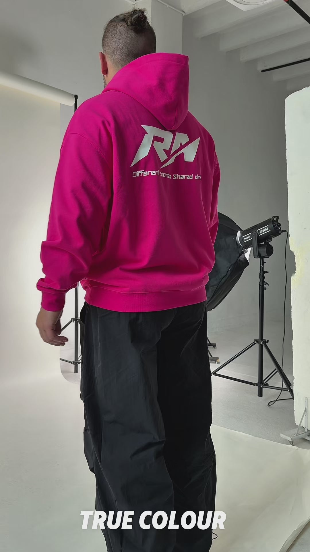 Back view of the Racer Nation RN OG oversized hoodie in Hyper Pink, showing the large white Racer Nation logo.