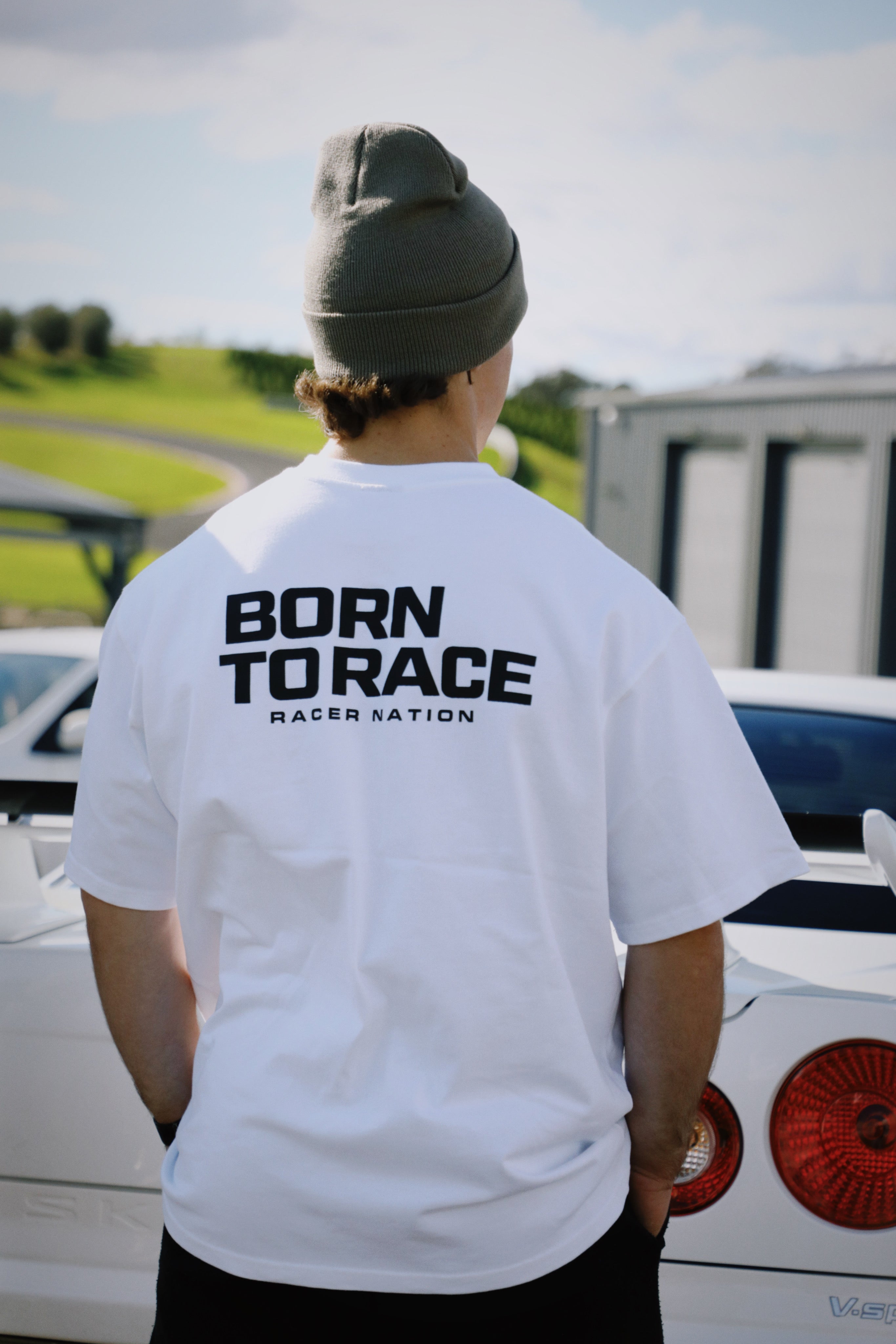 Back view of Racer Nation Born To Race white oversized tee showing black Born To Race graphic