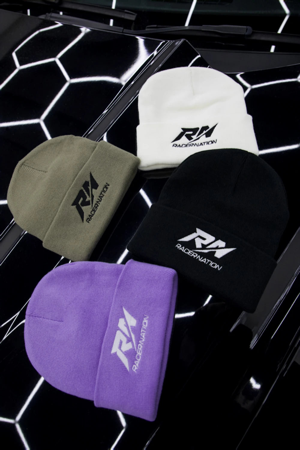 Racer Nation embroidered beanies in black, white, khaki and purple, each featuring the RN logo.