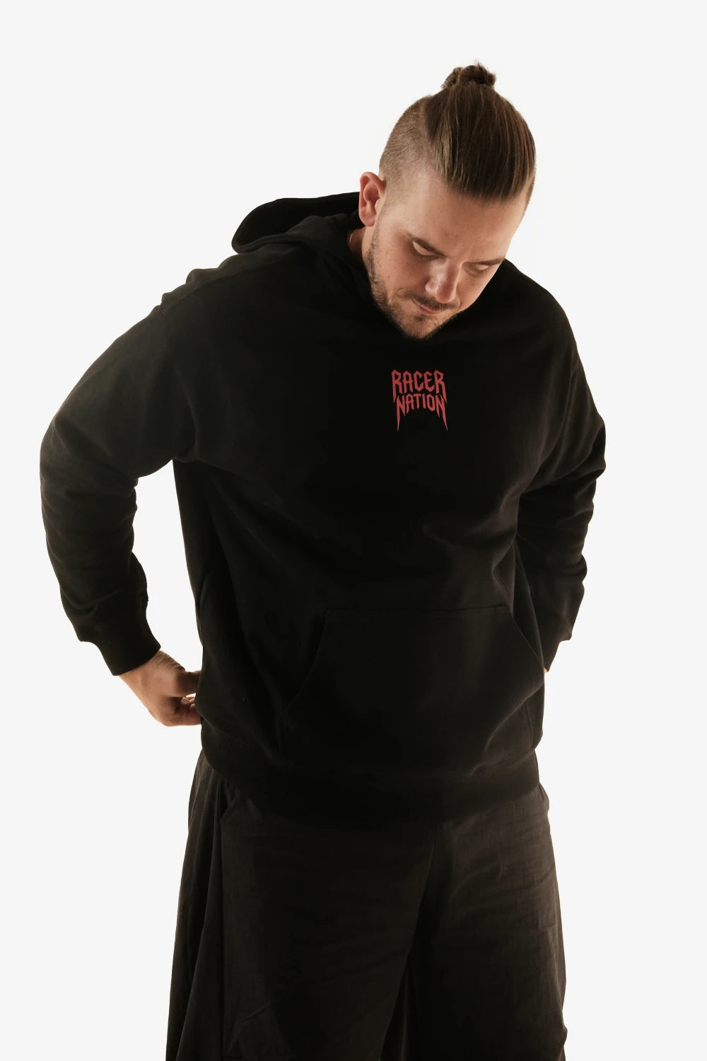 Front view of a model wearing the Racer Nation Ghost Rider black oversized hoodie with a red chest logo.