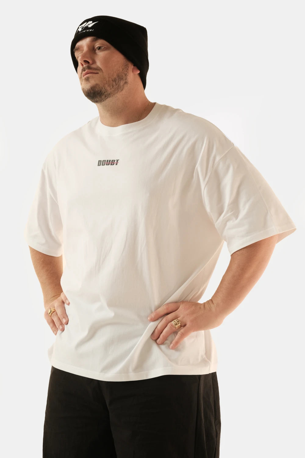 Male model wearing Racer Nation No Doubt white oversized tee showing small front chest logo and relaxed oversized fit