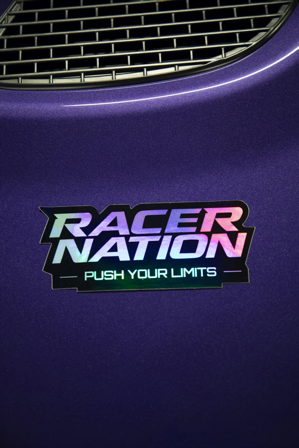 Holographic Racer Nation Push Your Limits sticker displayed on a purple car, showing its colour-shifting finish.