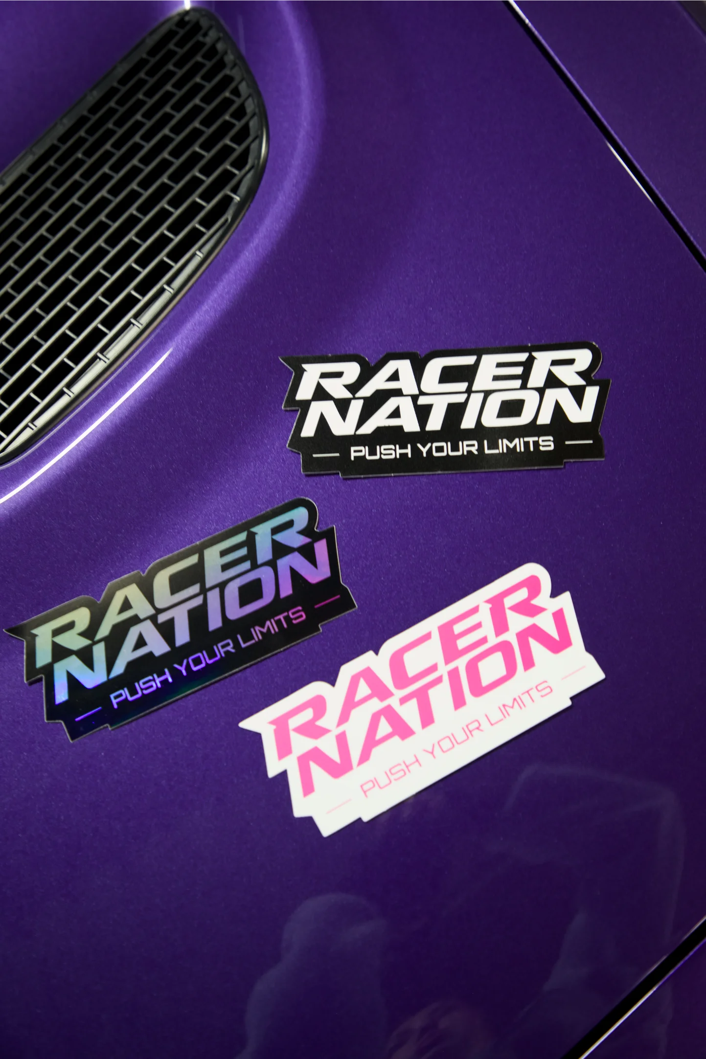 Racer Nation Push Your Limits die cut stickers shown in black and white, holographic and pink colour options.