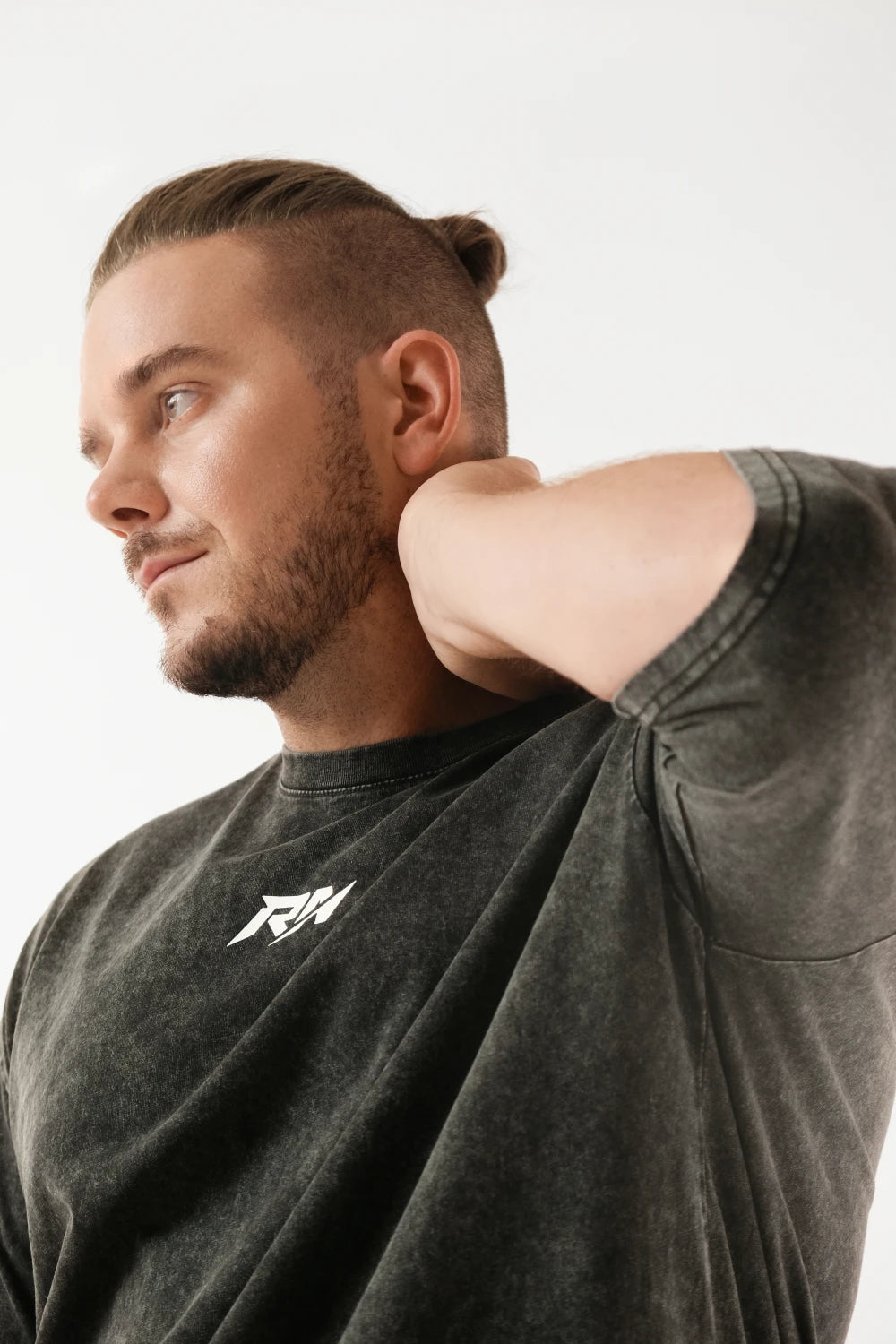 Male model wearing Racer Nation RN OG black acid washed oversized tee with white front chest logo