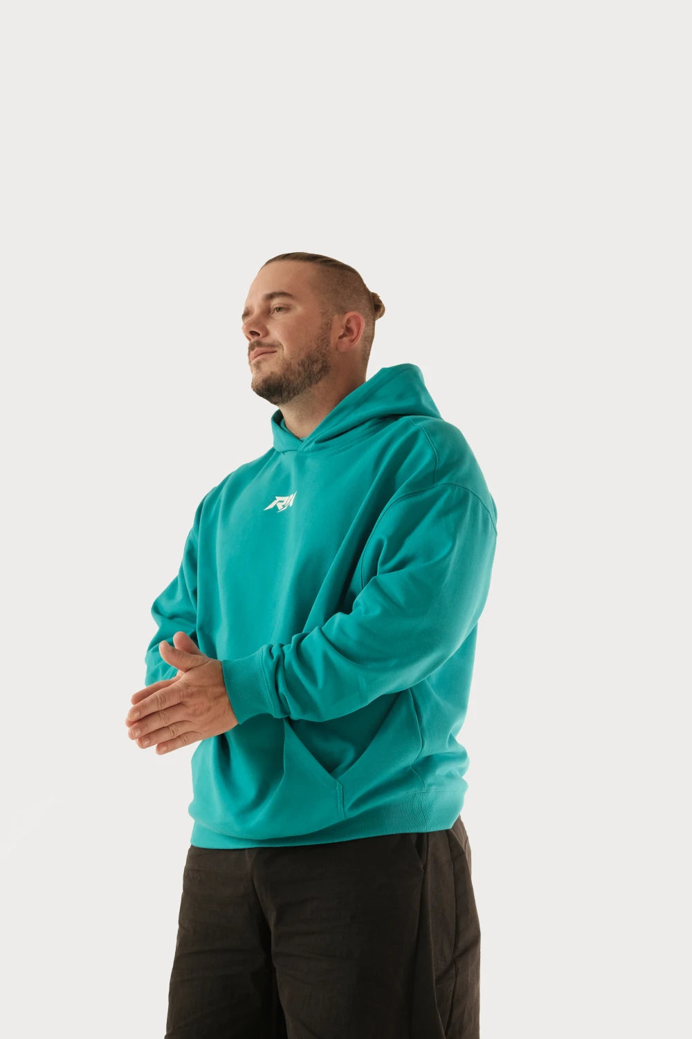 Male model wearing Racer Nation RN OG oversized hoodie in Tiffany Blue showing front chest logo and relaxed fit