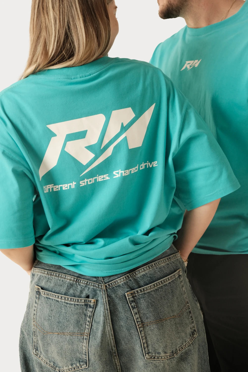 Male and female models wearing Racer Nation RN OG Tiffany Blue oversized tee showing white front chest logo and large white back logo