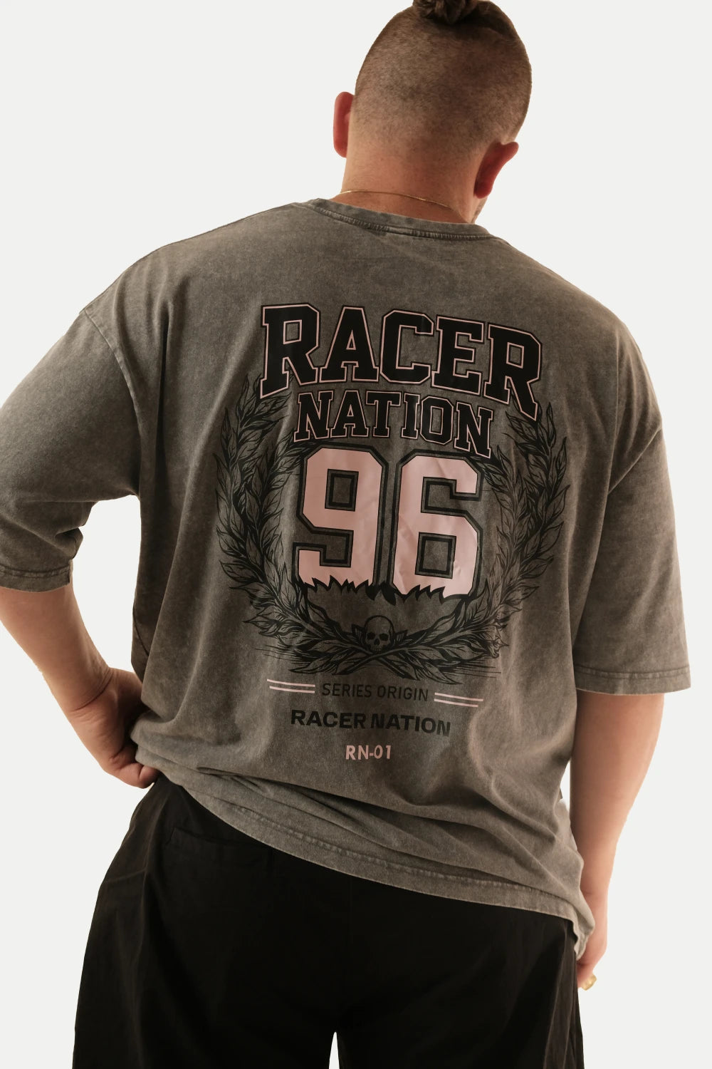 Male model wearing Racer Nation RN 01 grey acid washed oversized tee showing large 96 back graphic