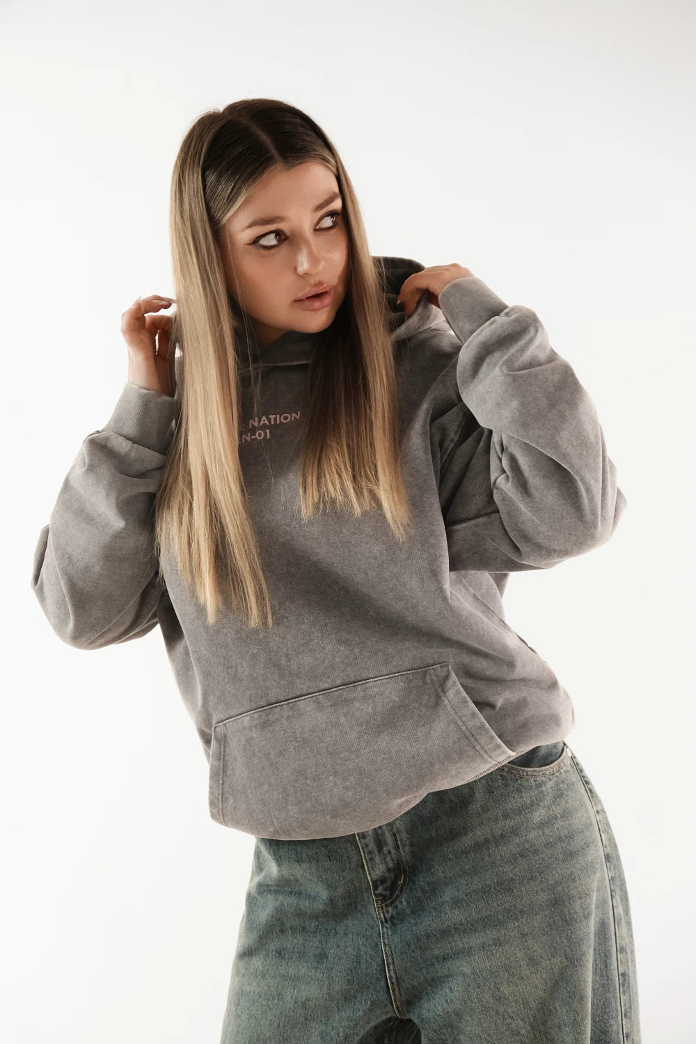 Model wearing Racer Nation RN 01 grey oversized acid wash hoodie showing front fit and chest logo