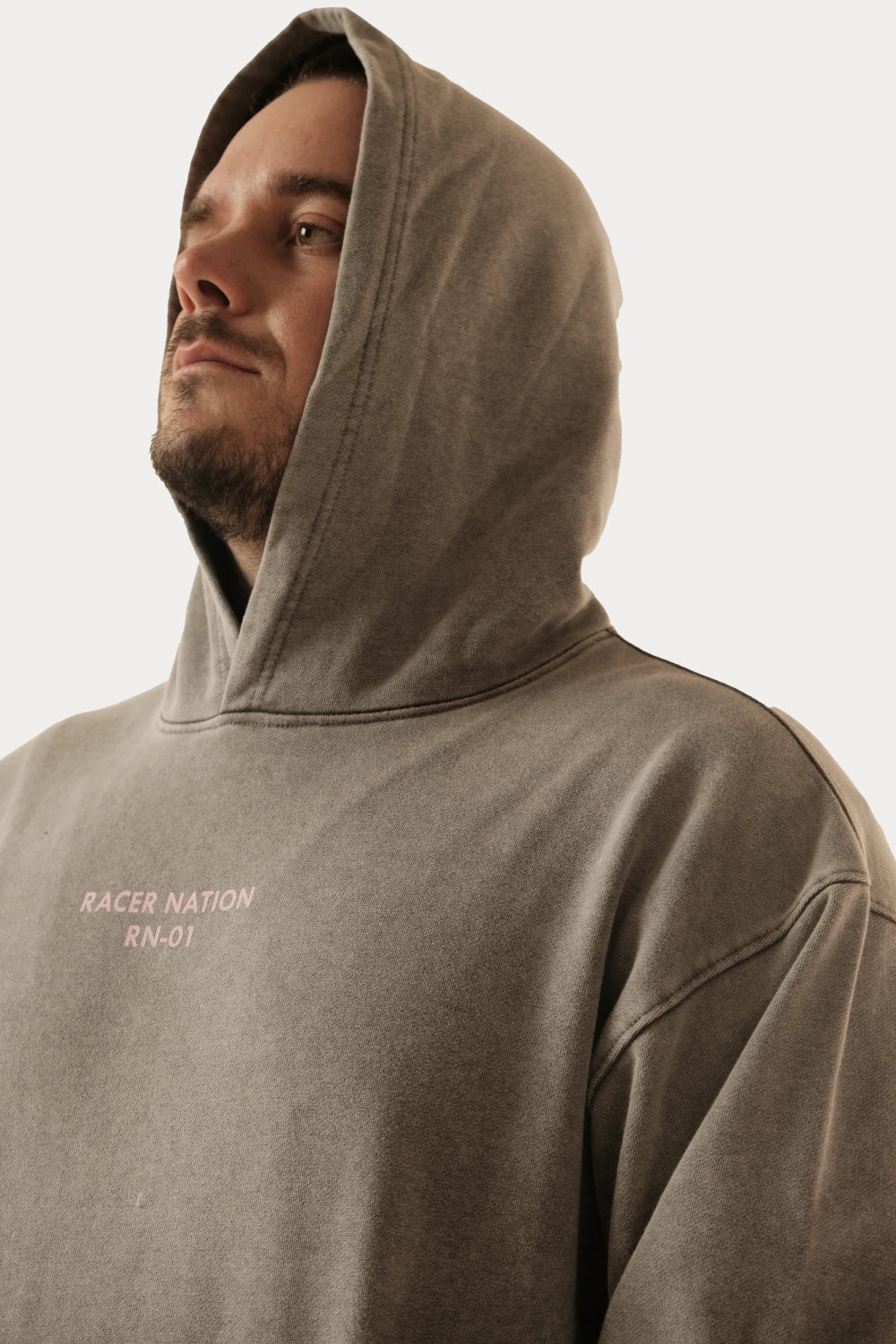 Male model wearing Racer Nation RN 01 grey oversized acid wash hoodie